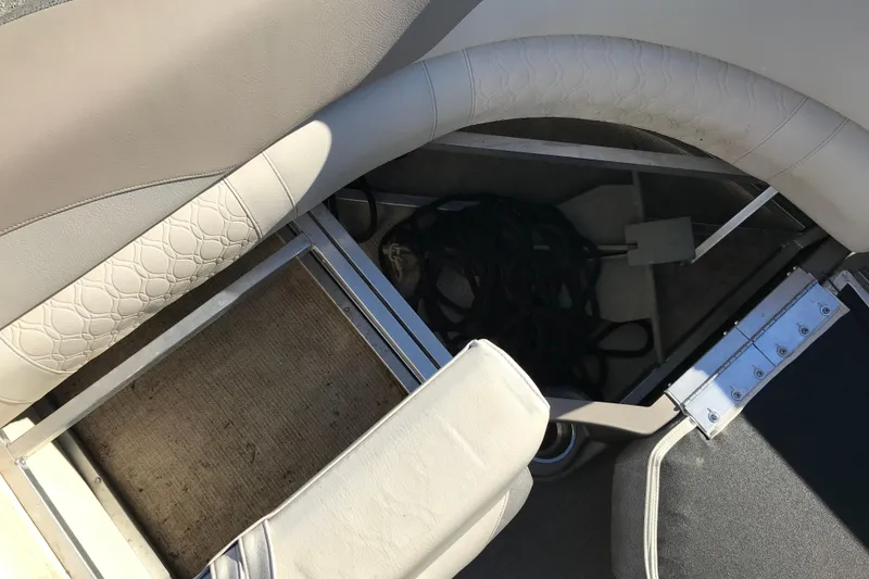 Slide: The Image of 2023 Avalon LSZ Rear Fish boat storage compartment with seating and rope. - 14