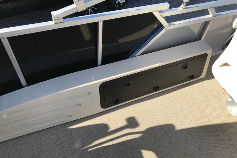 Slide: The Image of 2023 Avalon LSZ Rear Fish boat interior with storage compartment and railing. - 17