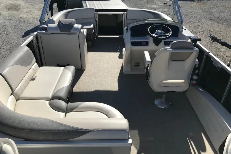 Slide: The Image of 2023 Avalon LSZ Rear Fish boat interior with plush seating and steering console. - 18