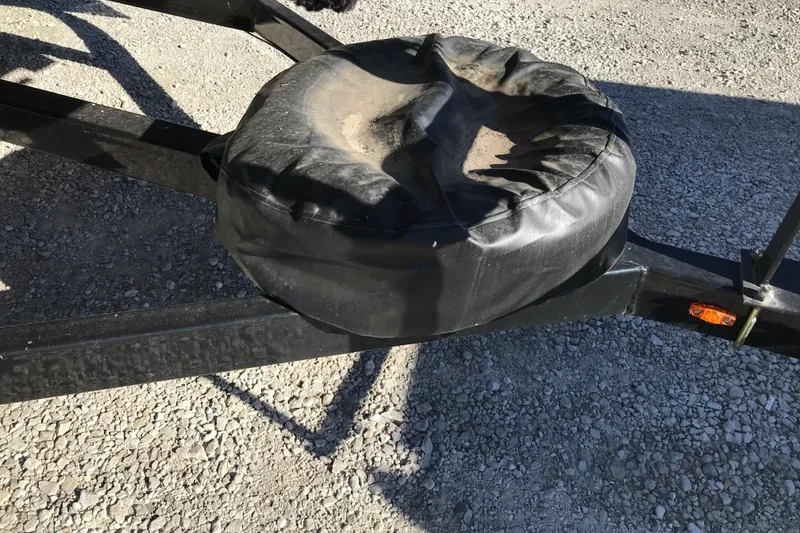 Slide: The Image of Trailer hitch with a black cover on gravel, 2023 Avalon LSZ Rear Fish. - 24