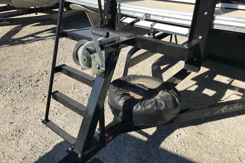 Slide: The Image of 2023 Avalon LSZ Rear Fish trailer hitch and winch mechanism on gravel surface. - 25