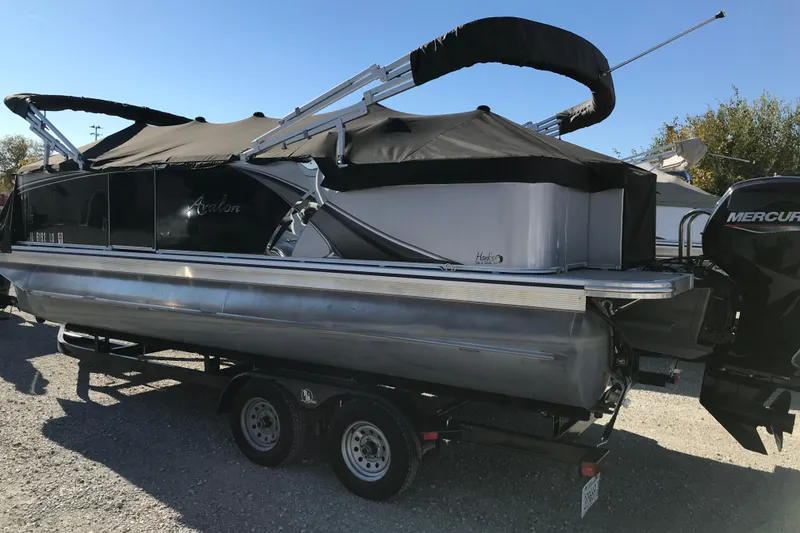 Slide: The Image of 2023 Avalon LSZ Rear Fish pontoon boat with Mercury engine on trailer. - 27