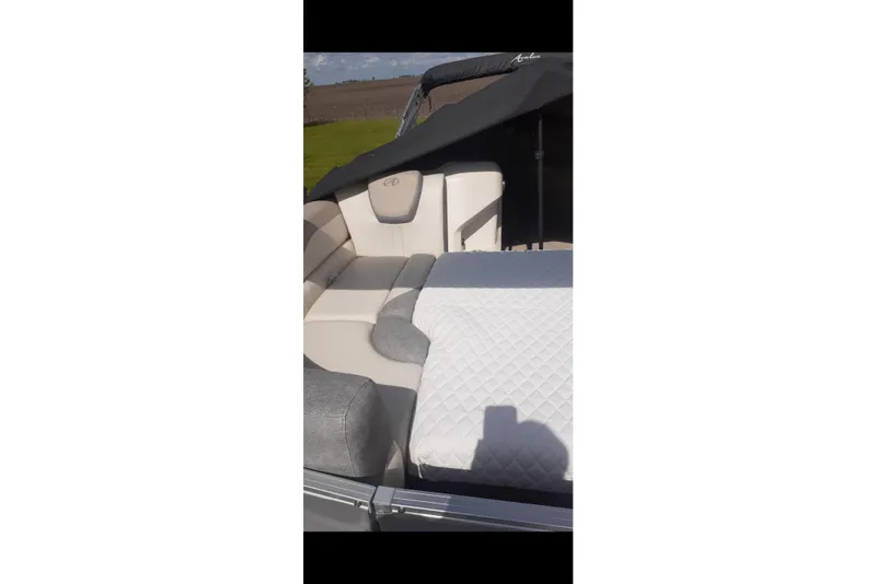 Slide: The Image of 2023 Avalon LSZ Rear Fish boat interior with cushioned seating and quilted surface. - 33