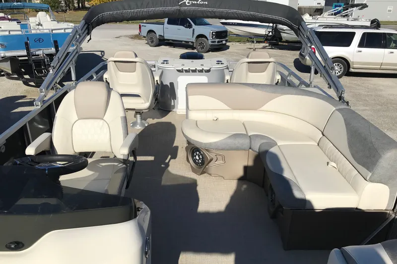 Slide: The Image of 2023 Avalon LSZ Rear Fish pontoon boat interior with seating and steering console. - 6