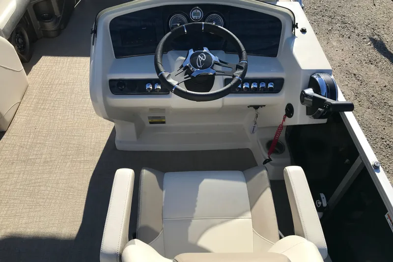Slide: The Image of 2023 Avalon LSZ Rear Fish boat helm with steering wheel and control panel. - 7