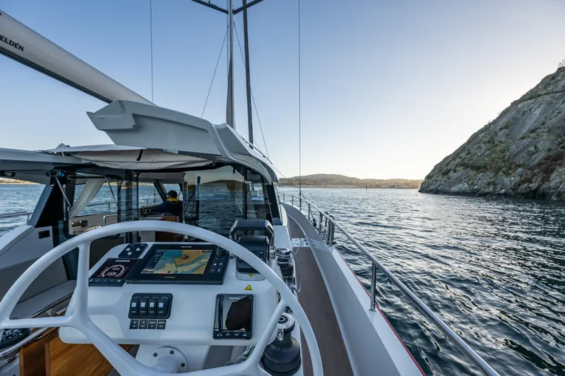 Slide: The Image of 2024 Moody 41ds yacht steering wheel and navigation system on open water. - 12