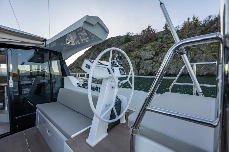 Slide: The Image of 2024 Moody 41ds yacht helm with modern design, featuring a sleek steering wheel and comfortable seating. - 13