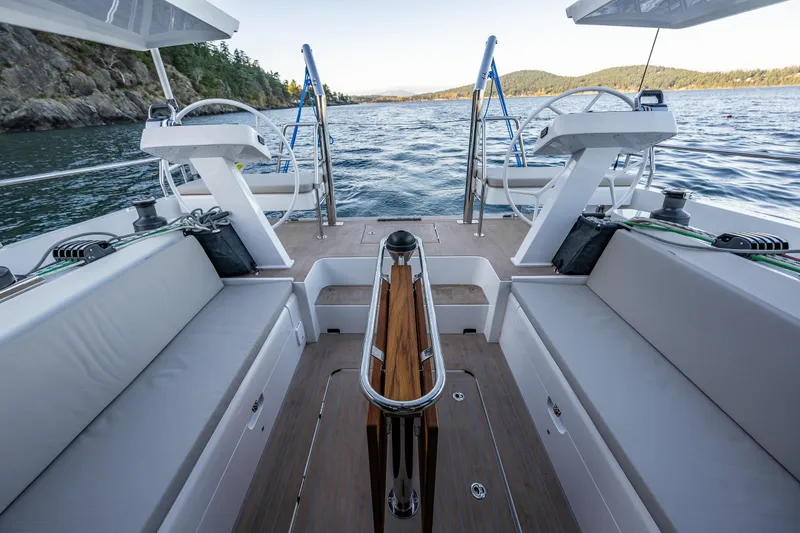Slide: The Image of 2024 Moody 41ds yacht cockpit with dual steering wheels, scenic water view. - 14