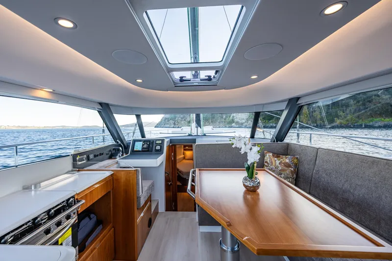 Slide: The Image of Luxurious interior of 2024 Moody 41ds yacht with panoramic windows and elegant dining area. - 15