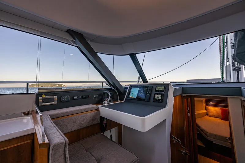 Slide: The Image of 2024 Moody 41ds yacht interior with navigation controls and cozy cabin view. - 18