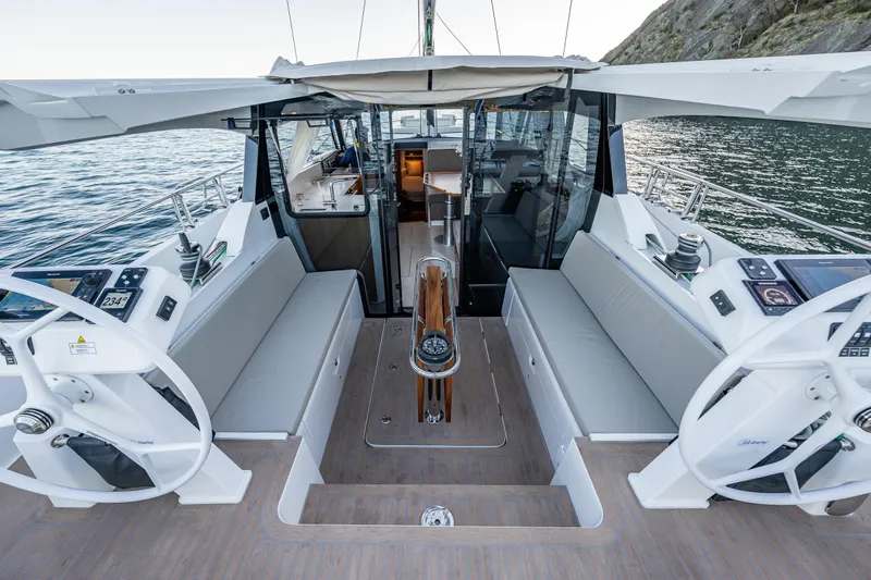 Slide: The Image of 2024 Moody 41DS yacht cockpit with dual steering wheels and modern navigation systems. - 2