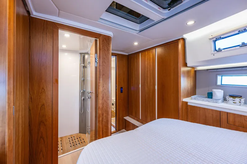 Slide: The Image of Luxurious 2024 Moody 41ds yacht interior with wood paneling and modern bathroom. - 25
