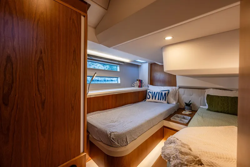 Slide: The Image of Luxurious 2024 Moody 41ds yacht cabin with cozy twin beds and elegant wood finish. - 27