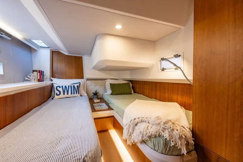 Slide: The Image of Luxurious 2024 Moody 41ds yacht cabin with twin beds and elegant wood paneling. - 28