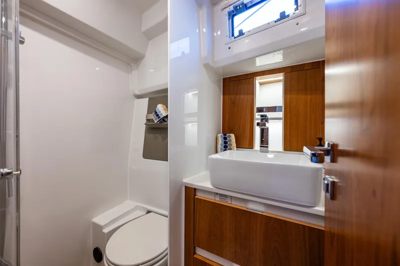 Slide: The Image of Modern bathroom in 2024 Moody 41ds yacht with sleek fixtures and wooden cabinetry. - 29