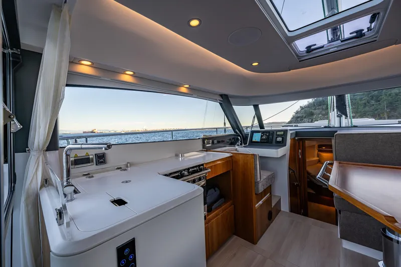 Slide: The Image of Luxurious interior of 2024 Moody 41ds yacht with modern kitchen and ocean view. - 3