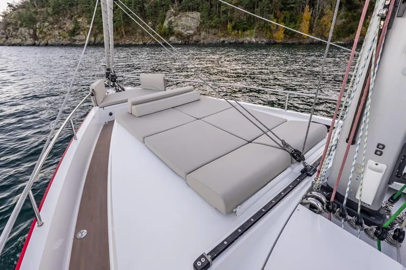 Slide: The Image of 2024 Moody 41ds sailboat with spacious deck and comfortable seating, cruising near forested shoreline. - 31