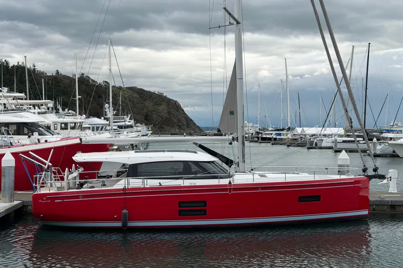 Slide: The Image of Red 2024 Moody 41ds sailboat docked in a marina under cloudy skies. - 38