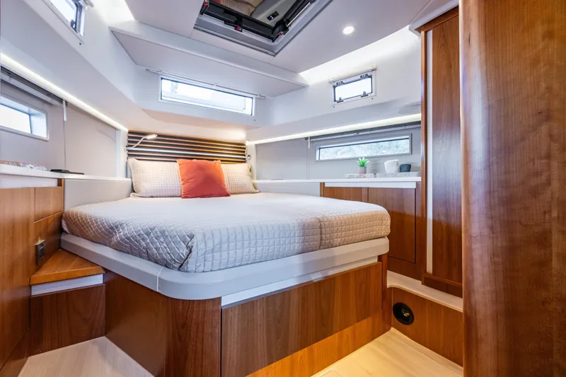 Slide: The Image of Luxurious 2024 Moody 41ds yacht cabin with modern wood finish and cozy bedding. - 4