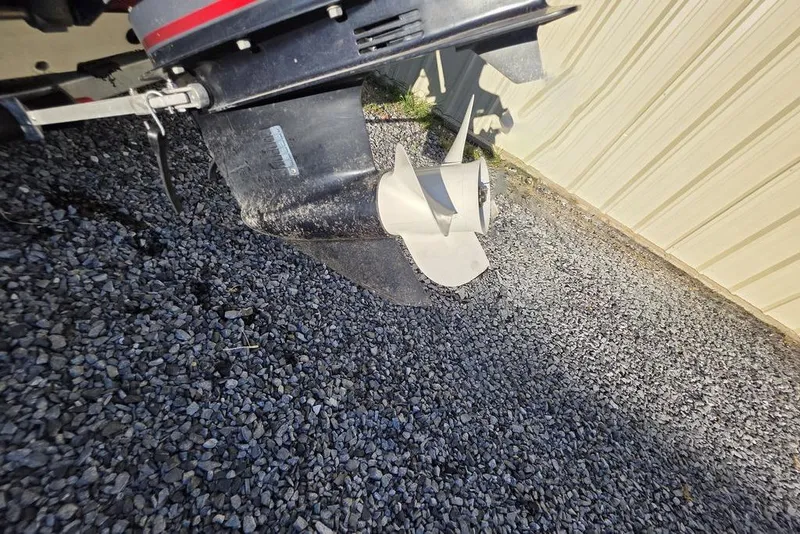 Slide: The Image of 2016 Xpress H20B Bay boat propeller on gravel surface near metal building. - 20