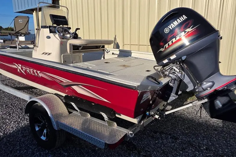 Slide: The Image of 2016 Xpress H20B Bay boat with Yamaha motor, parked on gravel. - 5