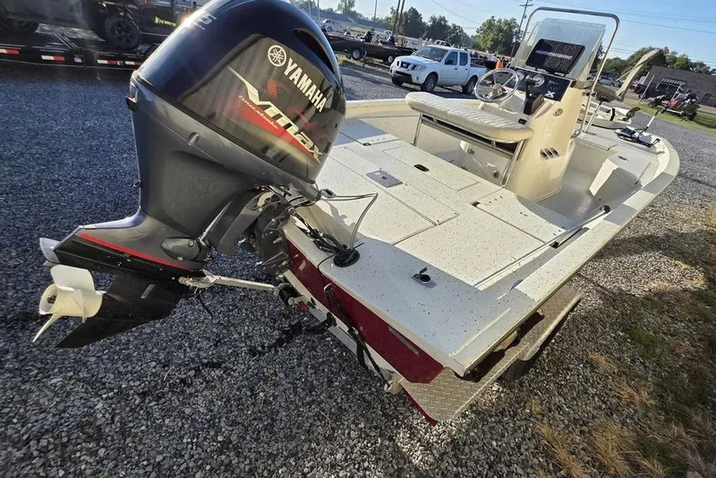 Slide: The Image of 2016 Xpress H20B Bay boat with Yamaha outboard motor on gravel lot. - 8