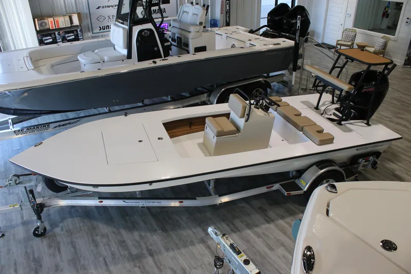 The Image of 2026 East Cape Vantage boat in showroom, featuring sleek design and modern seating. - 0