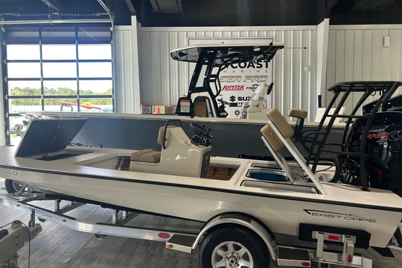 Slide: The Image of 2026 East Cape Vantage boat displayed indoors on a trailer. - 11