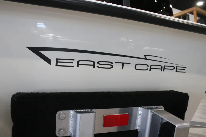Slide: The Image of 2026 East Cape Vantage boat logo on white hull with metal fixture. - 5