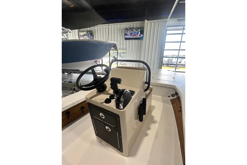 Slide: The Image of 2026 East Cape Vantage boat console with steering wheel and controls in showroom. - 9
