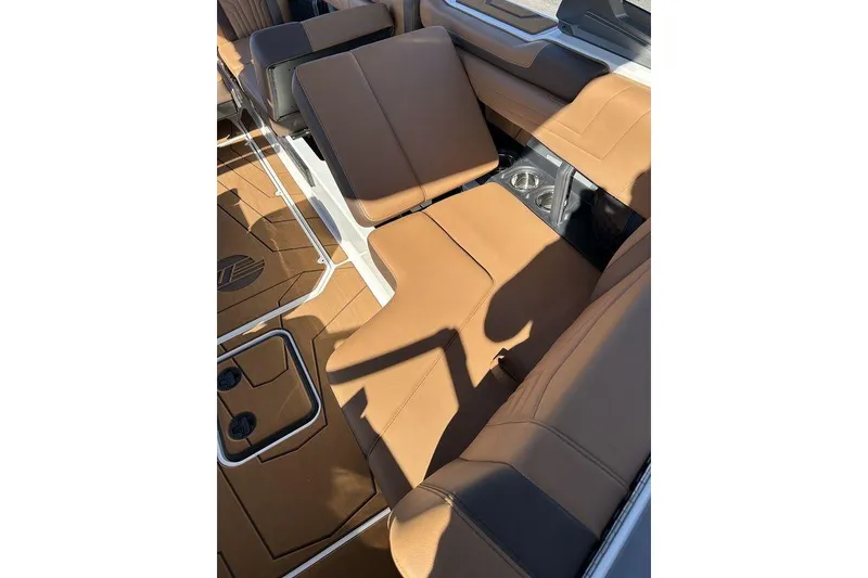 Slide: The Image of 2026 Malibu Sunscape 25 LSV interior with tan leather seating and cup holders. - 10