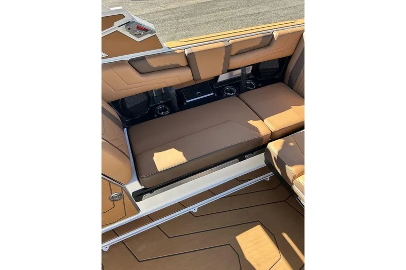 Slide: The Image of 2026 Malibu Sunscape 25 LSV interior with tan leather seating and cup holders. - 13