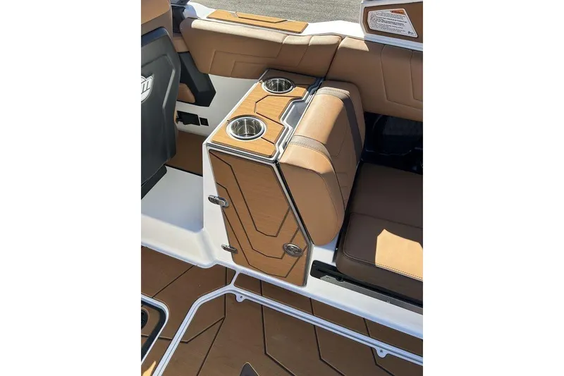 Slide: The Image of 2026 Malibu Sunscape 25 LSV interior with tan seating and cup holders. - 18