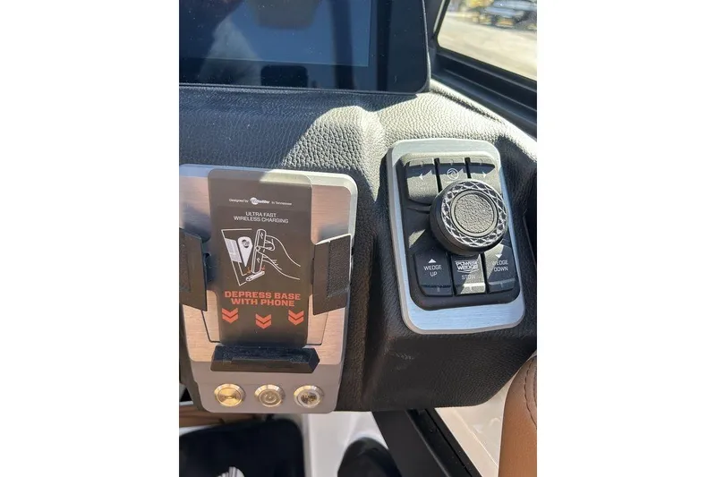 Slide: The Image of 2026 Malibu Sunscape 25 LSV dashboard with wireless charging and control panel. - 24