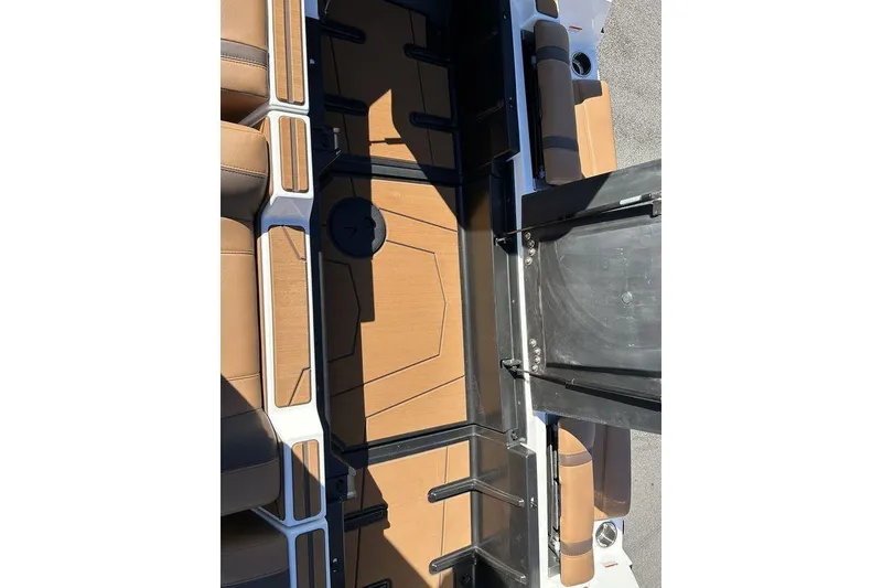 Slide: The Image of 2026 Malibu Sunscape 25 LSV boat interior with tan seating and sleek design. - 25