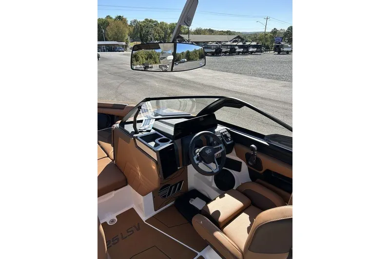 Slide: The Image of 2026 Malibu Sunscape 25 LSV boat interior with sleek dashboard and comfortable seating. - 27