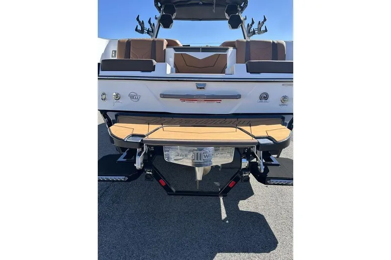 Slide: The Image of 2026 Malibu Sunscape 25 LSV boat rear view with teak swim platform and seating. - 4