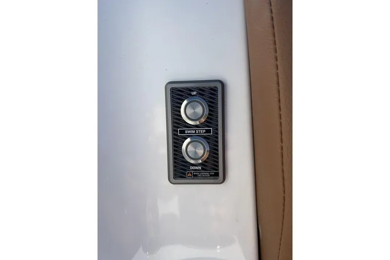 Slide: The Image of Control panel on 2026 Malibu Sunscape 25 LSV boat, featuring swim step buttons. - 6