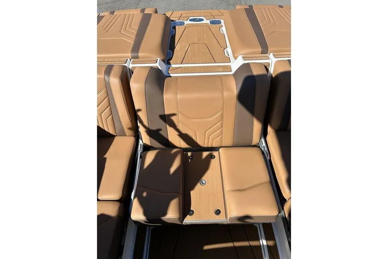 Slide: The Image of 2026 Malibu Sunscape 25 LSV boat interior with tan leather seating and sleek design. - 7