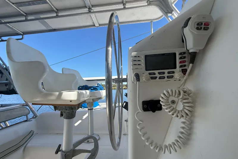 Slide: The Image of Cockpit of 1995 Manta Sailing Catamaran with steering wheel and communication radio. - 12