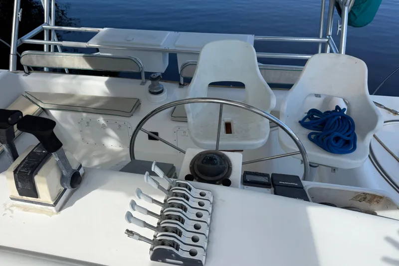 Slide: The Image of Cockpit of 1995 Manta Sailing Catamaran with steering wheel, controls, and seating. - 14