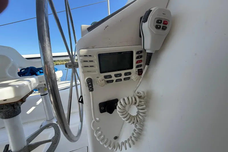 Slide: The Image of Steering wheel and radio controls on a 1995 Manta Sailing Catamaran. - 16