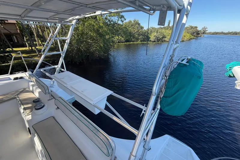 Slide: The Image of 1995 Manta SAILING CATAMARAN on tranquil waterway, featuring spacious deck and seating area. - 18