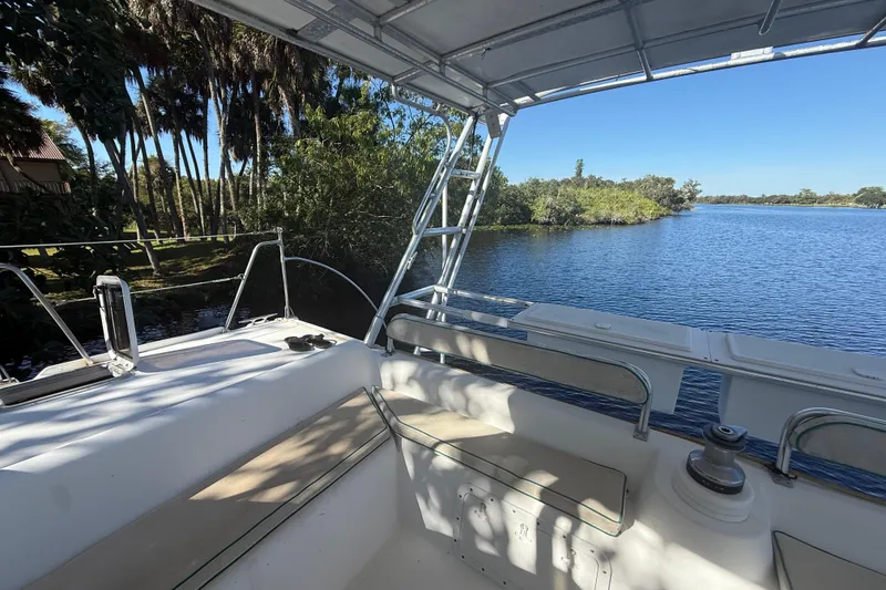 Slide: The Image of 1995 Manta SAILING CATAMARAN cockpit with scenic river view and lush greenery. - 19