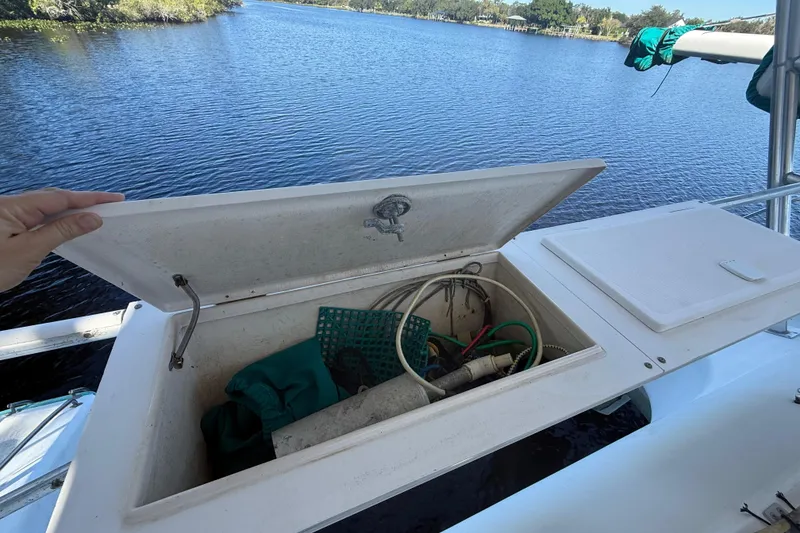Slide: The Image of Open storage compartment on 1995 Manta SAILING CATAMARAN with various boating equipment inside. - 22