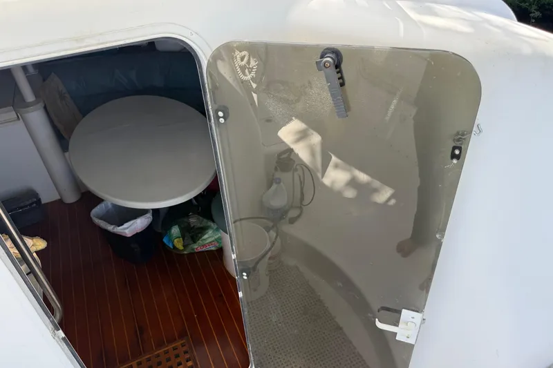 Slide: The Image of Interior view of a 1995 Manta SAILING CATAMARAN with a round table and wooden floor. - 23