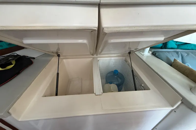 Slide: The Image of Open storage compartment on 1995 Manta SAILING CATAMARAN with water containers inside. - 28