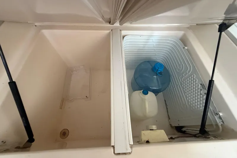 Slide: The Image of Storage compartment on 1995 Manta SAILING CATAMARAN with water containers inside. - 29