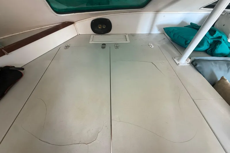 Slide: The Image of Interior cabin of a 1995 Manta SAILING CATAMARAN with storage compartments and teal cushions. - 30