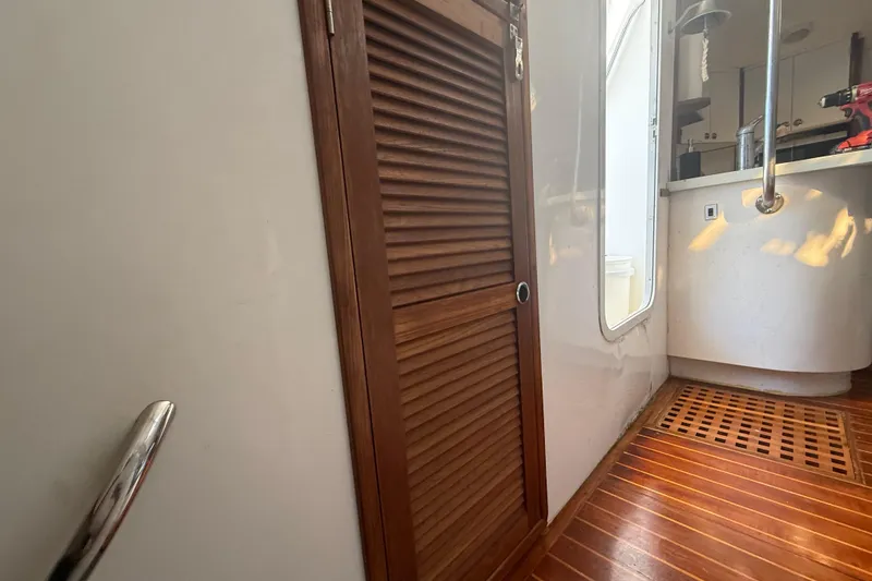 Slide: The Image of Interior of 1995 Manta Sailing Catamaran with wooden door and modern fixtures. - 34